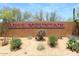 Welcoming community entrance sign surrounded by desert landscaping and vibrant greenery at 5626 E Sleepy Ranch Rd, Cave Creek, AZ 85331