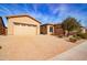 Tan house with a three-car garage and a brick driveway at 5626 E Sleepy Ranch Rd, Cave Creek, AZ 85331