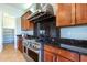 Modern kitchen with gas range and dark granite countertops at 5626 E Sleepy Ranch Rd, Cave Creek, AZ 85331