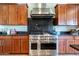 Modern kitchen with stainless steel range and dark wood cabinets at 5626 E Sleepy Ranch Rd, Cave Creek, AZ 85331