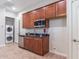 This kitchenette features cherry wood cabinets, stainless appliances, and a granite countertop at 5626 E Sleepy Ranch Rd, Cave Creek, AZ 85331