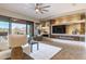 Open living room with modern fireplace, large television, and sliding glass doors at 5626 E Sleepy Ranch Rd, Cave Creek, AZ 85331