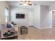 Bright living room with neutral walls, a ceiling fan, and a comfortable couch with blue pillows at 5626 E Sleepy Ranch Rd, Cave Creek, AZ 85331