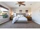 Bright main bedroom featuring a large bed, windows, and neutral colored walls at 5626 E Sleepy Ranch Rd, Cave Creek, AZ 85331