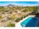 Aerial view of a sparkling backyard pool surrounded by desert landscaping and mountain views at 5626 E Sleepy Ranch Rd, Cave Creek, AZ 85331