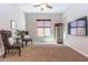 Cozy sitting room with two chairs, carpet floors, and a mounted television at 5626 E Sleepy Ranch Rd, Cave Creek, AZ 85331