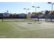 Modern tennis court with ample lighting for evening play at 5735 E Mcdowell Rd # 38, Mesa, AZ 85215