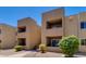 Tan two-story condo building with balconies and landscaping at 5877 N Granite Reef Rd # 2225, Scottsdale, AZ 85250