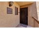 Condo building entrance with a black metal door and welcome mat at 5877 N Granite Reef Rd # 2225, Scottsdale, AZ 85250