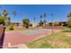 Community tennis court with red surface and surrounding landscaping at 5877 N Granite Reef Rd # 2225, Scottsdale, AZ 85250