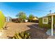 Large backyard with gravel, cacti, and storage shed at 59 N Adams St, Wickenburg, AZ 85390