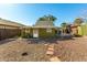 Green house with a walkway and desert landscaping at 59 N Adams St, Wickenburg, AZ 85390