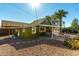 Green house with a covered patio and desert landscaping at 59 N Adams St, Wickenburg, AZ 85390