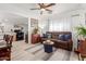 Open concept living room and kitchen, featuring a comfortable brown sofa and dining area at 59 N Adams St, Wickenburg, AZ 85390