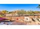 Landscaped backyard with a stone fireplace and seating area at 5902 W Gambit Trl, Phoenix, AZ 85083