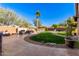 Landscaped backyard with pool, fireplace, and grassy area at 5902 W Gambit Trl, Phoenix, AZ 85083