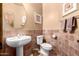 Well-appointed bathroom with tiled floors and a pedestal sink at 5902 W Gambit Trl, Phoenix, AZ 85083