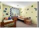 Bright bedroom with twin beds, wood accents, and playful wall decor at 5902 W Gambit Trl, Phoenix, AZ 85083