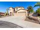 Two-story home with a three-car garage and desert landscaping at 5902 W Gambit Trl, Phoenix, AZ 85083