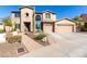 Two-story house with a large front yard, three-car garage, and a paved driveway at 5902 W Gambit Trl, Phoenix, AZ 85083