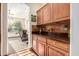 Walk-in pantry with wood cabinets and granite countertops at 5902 W Gambit Trl, Phoenix, AZ 85083