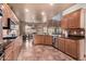 Spacious kitchen with an island, stainless steel appliances, and terracotta flooring at 5902 W Gambit Trl, Phoenix, AZ 85083