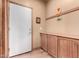 Well-lit laundry room with wooden cabinets and tiled floor at 5902 W Gambit Trl, Phoenix, AZ 85083