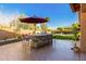 Outdoor kitchen with brick counter, built-in grill, and seating area at 5902 W Gambit Trl, Phoenix, AZ 85083