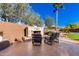 Patio with fireplace, comfortable seating, and desert landscaping at 5902 W Gambit Trl, Phoenix, AZ 85083