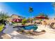 Relaxing pool area with spacious patio, palm tree, and lounge chairs at 5902 W Gambit Trl, Phoenix, AZ 85083