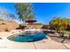 Inviting kidney-shaped pool with surrounding patio and landscaping at 5902 W Gambit Trl, Phoenix, AZ 85083