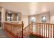 Upstairs hall with wood railing overlooking the main floor at 5902 W Gambit Trl, Phoenix, AZ 85083