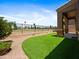 An artificial turf yard, complimented by stone landscaping and a view of the common area at 6202 E Mckellips Rd # 83, Mesa, AZ 85215