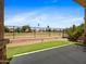View of a backyard featuring a nice patch of artificial turf and an iron fence to a common green area at 6202 E Mckellips Rd # 83, Mesa, AZ 85215