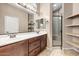 Double vanity bathroom with shower and shelving at 6202 E Mckellips Rd # 83, Mesa, AZ 85215