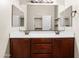 Bathroom with a double sink vanity and large mirror, and a walk-in closet at 6202 E Mckellips Rd # 83, Mesa, AZ 85215