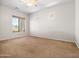 Bright and airy bedroom with neutral carpet, a ceiling fan, and natural light from a large window at 6202 E Mckellips Rd # 83, Mesa, AZ 85215