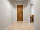 Inviting entryway with tile flooring and a solid wood door, leading to the rest of the home at 6202 E Mckellips Rd # 83, Mesa, AZ 85215
