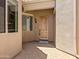 Covered entryway with a solid wood front door and low-maintenance landscaping, creating a welcoming entrance at 6202 E Mckellips Rd # 83, Mesa, AZ 85215