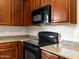The kitchen features dark wood cabinets and granite countertops and stainless steel appliances at 6202 E Mckellips Rd # 83, Mesa, AZ 85215