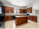 Modern kitchen features granite countertops, a center island, and dark wood cabinetry for a sleek design at 6202 E Mckellips Rd # 83, Mesa, AZ 85215