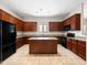 Spacious kitchen with a central island, and stylish dark wood cabinets, designed for efficiency and gatherings at 6202 E Mckellips Rd # 83, Mesa, AZ 85215