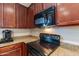 Modern kitchen with black appliances and wood cabinets at 6202 E Mckellips Rd # 83, Mesa, AZ 85215