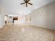 Spacious living room with neutral tile, ceiling fan, and ample natural light from well-placed windows at 6202 E Mckellips Rd # 83, Mesa, AZ 85215