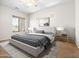 Stylishly furnished main bedroom featuring a large window, ceiling fan, and serene decor at 6202 E Mckellips Rd # 83, Mesa, AZ 85215