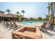 Community pool with a fire pit and plenty of lounge chairs at 6202 E Mckellips Rd # 83, Mesa, AZ 85215