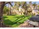 Community BBQ grills nestled in a grassy area with mature trees at 6540 N 7Th Ave # 49, Phoenix, AZ 85013