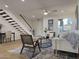 Light-filled living room featuring hardwood floors, stylish seating, and a view of the staircase at 6540 N 7Th Ave # 49, Phoenix, AZ 85013