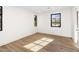 Light-filled bedroom featuring hardwood floors and large windows at 6644 E Cholla Dr, Paradise Valley, AZ 85253