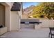 Modern outdoor kitchen with grill and stylish tile backsplash at 6644 E Cholla Dr, Paradise Valley, AZ 85253